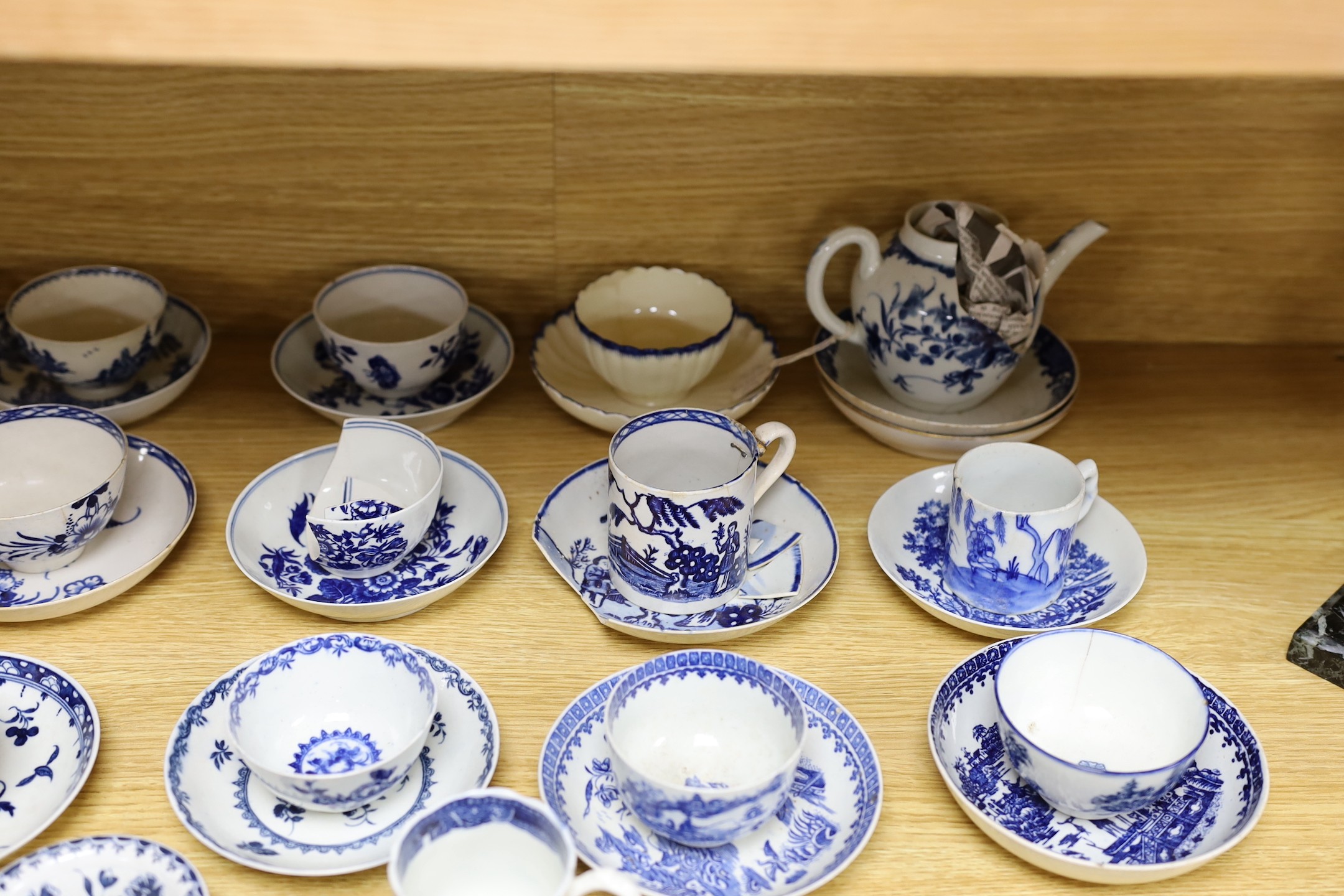 A large group of 18th century Worcester, Caughley and Liverpool blue and white tea bowls, coffee cups and saucers etc. including a Bow Cross-Legged Man